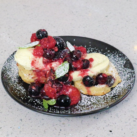 Berry compote with fruit scones and cream